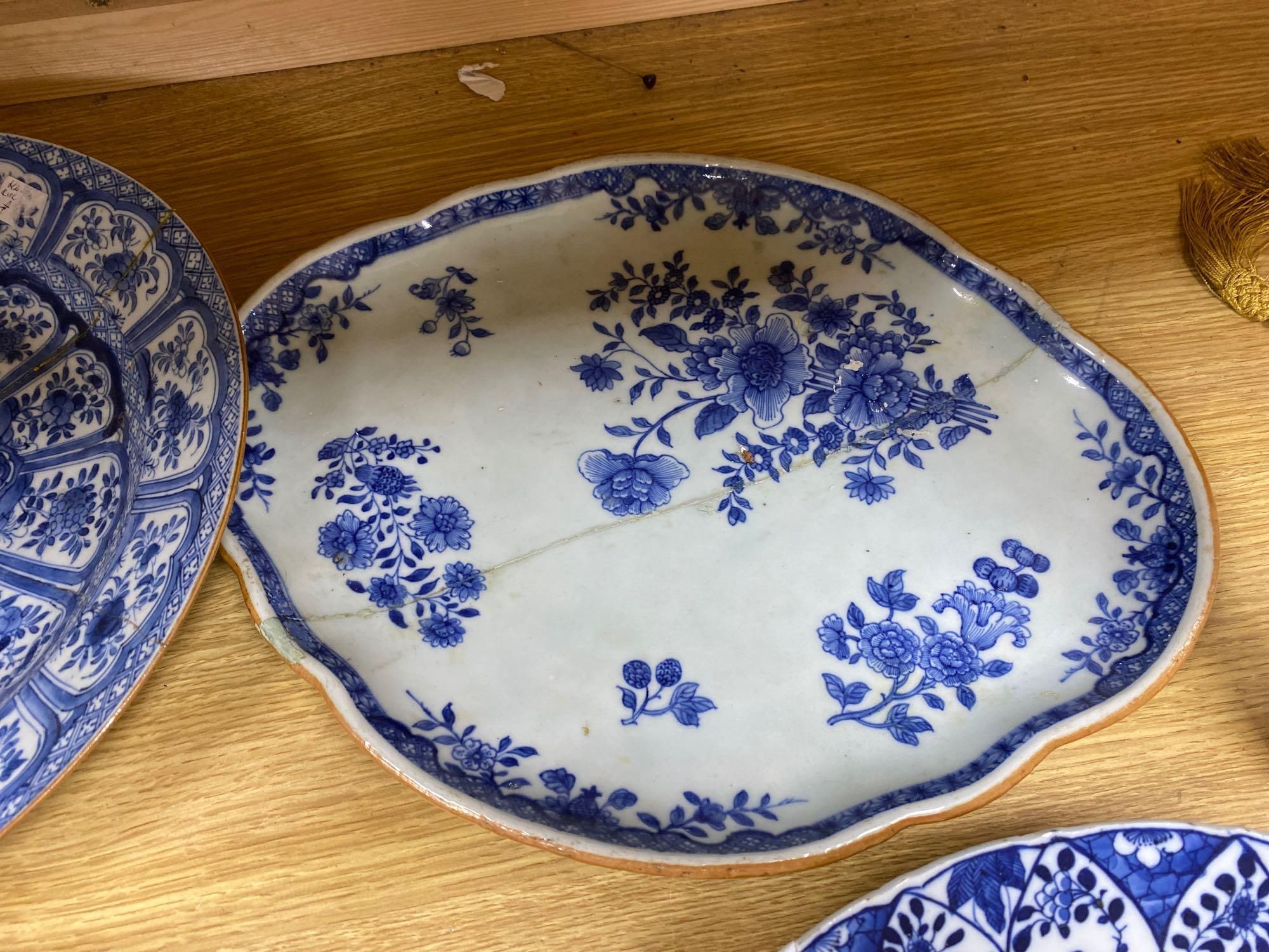 Four Chinese Kangxi period blue and white dishes and a Qianlong blue and white dish